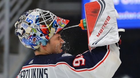 Elvis Merzlikins squirts water in his face during a stoppage against the St. Louis Blues