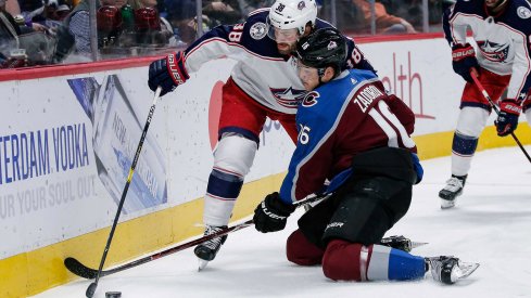 Feb 5, 2019; Denver, CO, USA; Columbus Blue Jackets center Boone Jenner (38) and Colorado Avalanche defenseman Nikita Zadorov (16) battle for the puck in the first period at the Pepsi Center.