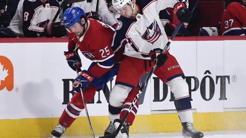 Nov 12, 2019; Montreal, Quebec, CAN; Montreal Canadiens forward Ryan Poehling (25) battles with Columbus Blue Jackets forward Emil Bemstrom (52) for possession of the puck during the second period at the Bell Centre.