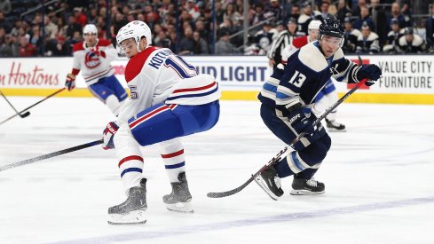 Nov 19, 2019; Columbus, OH, USA; Columbus Blue Jackets right wing Cam Atkinson (13) chips the puck past Montreal Canadiens center Jesperi Kotkaniemi (15) during the first period at Nationwide Arena.