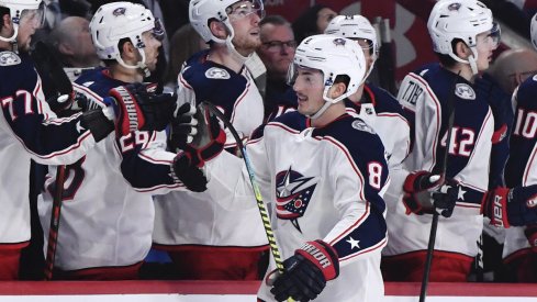 Columbus Blue Jackets defenseman Zach Werenski (8) reacts with teammates after scoring a goal against the Montreal Canadiens during the third period at the Bell Centre.