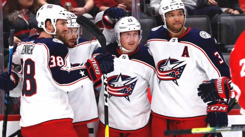 Columbus Blue Jackets right wing Oliver Bjorkstrand (28) receives congratulations from teammates after scoring in the first period against the Detroit Red Wings at Little Caesars Arena.