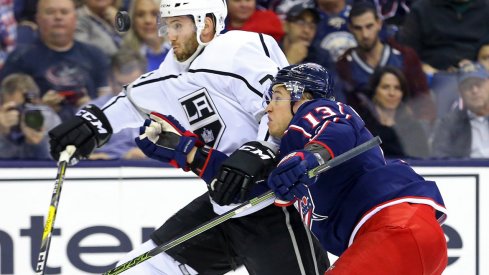Oct 21, 2017; Columbus, OH, USA; Columbus Blue Jackets right wing Cam Atkinson (13) battles for the puck against Los Angeles Kings defenseman Derek Forbort (24) in the third period at Nationwide Arena. Mandatory Credit: Aaron Doster-USA TODAY Sports