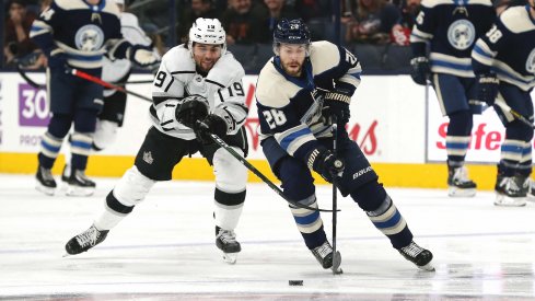 Dec 19, 2019; Columbus, OH, USA; Columbus Blue Jackets right wing Oliver Bjorkstrand (28) skates with the puck as Los Angeles Kings left wing Alex Iafallo (19) defends during the first period at Nationwide Arena.