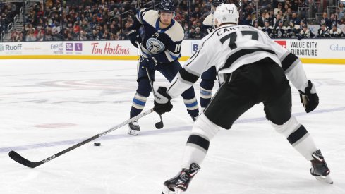 Columbus Blue Jackets center Alexander Wennberg (10) passes the puck as Los Angeles Kings right wing Jeff Carter (77) defends during the first period at Nationwide Arena.