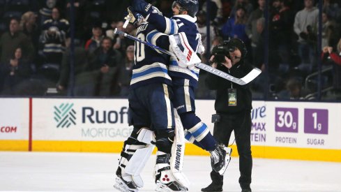 Dec 19, 2019; Columbus, OH, USA; Columbus Blue Jackets goalie Joonas Korpisalo (70) and left wing Nick Foligno (71) celebrate after defeating the Los Angeles Kings at Nationwide Arena.