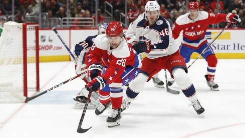 Washington Capitals left wing Brendan Leipsic (28) reaches for the puck in front of Columbus Blue Jackets goaltender Joonas Korpisalo (70) as Blue Jackets defenseman Dean Kukan (46) defends in the second period at Capital One Arena.