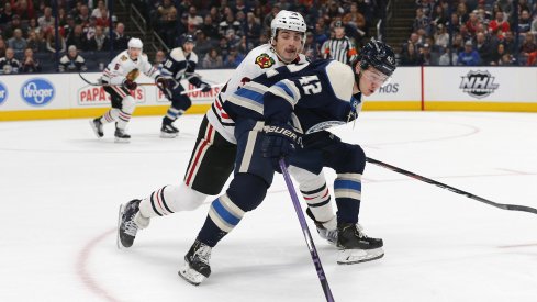 Dec 29, 2019; Columbus, Ohio, USA; Chicago Blackhawks defenseman Dennis Gilbert (39) steals the puck from Columbus Blue Jackets center Alexandre Texier (42) during the first period at Nationwide Arena.