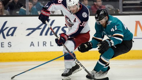 Mar 4, 2018; San Jose, CA, USA; Columbus Blue Jackets center Boone Jenner (38) and San Jose Sharks defenseman Joakim Ryan (47) fight for control of the puck during the third period at SAP Center at San Jose. Mandatory Credit: Stan Szeto-USA TODAY Sports