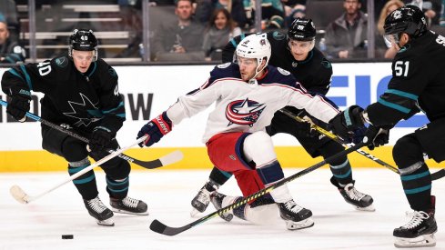 an 9, 2020; San Jose, California, USA; Columbus Blue Jackets center Alexander Wennberg (10) battles for the puck against San Jose Sharks center Antti Suomela (40) and defenseman Mario Ferraro (38) and defenseman Radim Simek (51) during the first period at SAP Center at San Jose.