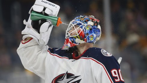 Columbus Blue Jackets goaltender Elvis Merzlikins (90) sprays water on his face during the third period against the Boston Bruins at TD Garden.