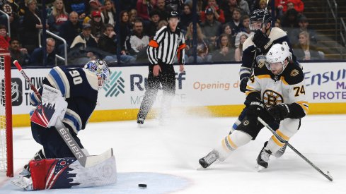 Columbus Blue Jackets goalie Elvis Merzlikins (90) makes a save from the shot of Boston Bruins left wing Jake DeBrusk (74) during the first period at Nationwide Arena.