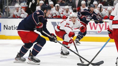 Columbus Blue Jackets defenseman Zach Werenski (8) carries the puck against Carolina Hurricanes right wing Martin Necas (88) during the first period at Nationwide Arena.