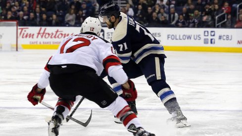 Dec 20, 2018; Columbus, OH, USA; Columbus Blue Jackets left wing Nick Foligno (71) passes the puck as New Jersey Devils defenseman Ben Lovejoy (12) defends during the second period at Nationwide Arena.