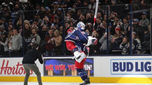 Columbus Blue Jackets goalie Elvis Merzlikins (90) and Columbus Blue Jackets left wing Nick Foligno (71) celebrate the win over the Carolina Hurricanes after the game at Nationwide Arena.