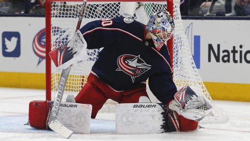 Jan 16, 2020; Columbus, Ohio, USA; Columbus Blue Jackets goalie Elvis Merzlikins (90) makes a glove save against the Carolina Hurricanes during the second period at Nationwide Arena.