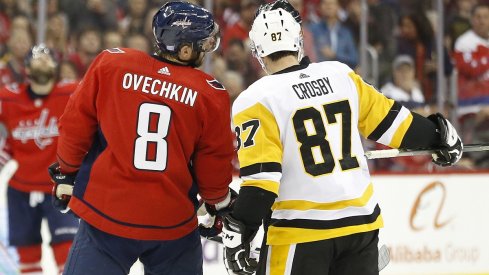 Sidney Crosby and Alex Ovechkin talk with referee Wes McCauley 