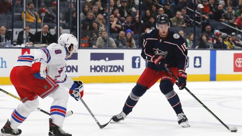 Columbus Blue Jackets center Pierre-Luc Dubois (18) passes the puck as New York Rangers defenseman Jacob Trouba (8) defends during the first period at Nationwide Arena.