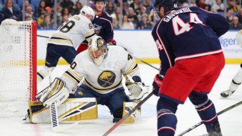 Feb 13, 2020; Buffalo, New York, USA; Buffalo Sabres goaltender Carter Hutton (40) looks to make a save on Columbus Blue Jackets defenseman Vladislav Gavrikov (44) during the first period at KeyBank Center. Mandatory Credit: Timothy T. Ludwig-USA TODAY Sports