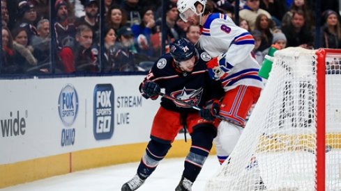 Columbus Blue Jackets forward Nathan Gerbe fights for the puck alongside New York Rangers defenseman Jacob Trouba during a game at Nationwide Arena.