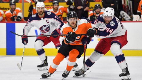 Feb 18, 2020; Philadelphia, Pennsylvania, USA; Philadelphia Flyers right wing Travis Konecny (11) and Columbus Blue Jackets defenseman Vladislav Gavrikov (44) battle for the puck during the second period during the first period at Wells Fargo Center.