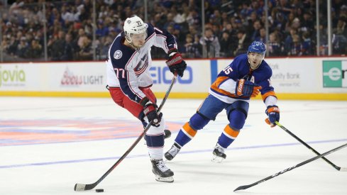 Nov 30, 2019; Brooklyn, NY, USA; Columbus Blue Jackets right wing Josh Anderson (77) shoots against New York Islanders right wing Cal Clutterbuck (15) during the third period at Barclays Center.