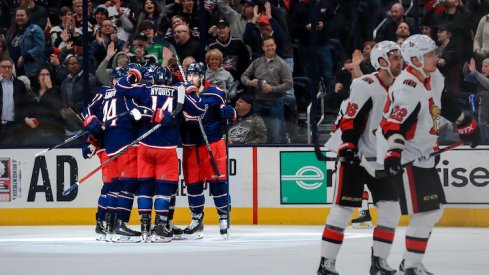 Columbus Blue Jackets left wing Nick Foligno (back) celebrates with teammates after scoring his second goal of the game against the Ottawa Senators in the second period at Nationwide Arena.