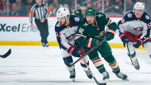 Feb 25, 2020; Saint Paul, Minnesota, USA; Minnesota Wild defenseman Jared Spurgeon (46) and Columbus Blue Jackets forward Emil Bemstrom (52) skate after the puck in the first period at Xcel Energy Center.