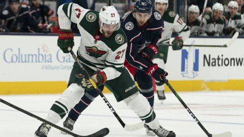 Alex Galchenyuk and Kevin Stenlund battle for the puck