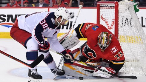 Calgary Flames goalie David Rittich (33) makes a save against Columbus Blue Jackets center Boone Jenner (38) during the second period at Scotiabank Saddledome. 