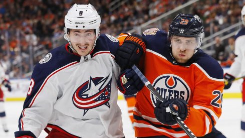 Mar 21, 2019; Edmonton, Alberta, CAN; Columbus Blue Jackets defensemen Zack Werenski (8) and Edmonton Oilers forward Leon Draisaitl (29) battle for position during the third period at Rogers Place.