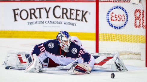 Columbus Blue Jackets goaltender Joonas Korpisalo (70) makes a save against the Calgary Flames during the third period at Scotiabank Saddledome.