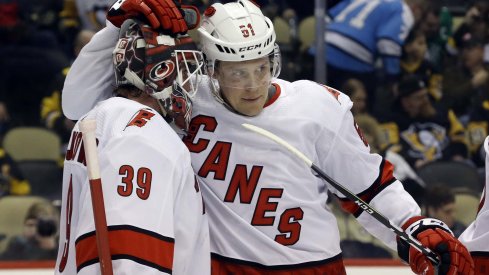 Carolina Hurricanes goaltender Alex Nedeljkovic (39) and defenseman Jake Gardiner (51) celebrate after defeating the Pittsburgh Penguins at PPG PAINTS Arena. The Hurricanes won 6-2.