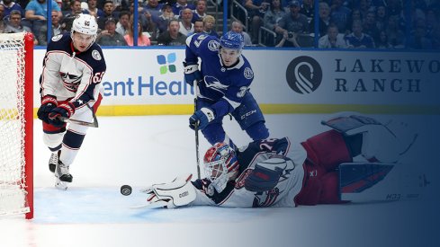 Columbus Blue Jackets goaltender Sergei Bobrovsky reaches for a puck as Yanni Gourde of the Tampa Bay Lightning approaches during Game 1 at Amalie Arena.