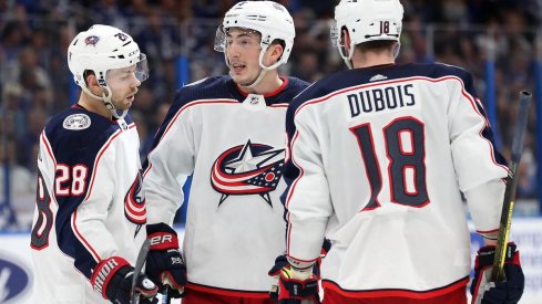 Columbus Blue Jackets defenseman Zach Werenski (8) celebrates with teammates after scoring a goal against the Tampa Bay Lightning at Amalie Arena. 