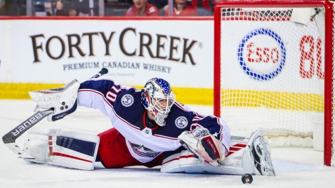 Columbus Blue Jackets goaltender Joonas Korpisalo (70) makes a save against the Calgary Flames during the third period at Scotiabank Saddledome.