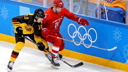 Germany defenseman Christian Ehrhoff (10) and Olympic Athlete from Russia forward Mikhail Grigorenko (25) go for the puck in the men's ice hockey gold medal match during the Pyeongchang 2018 Olympic Winter Games at Gangneung Hockey Centre.