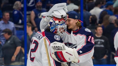 Korpisalo and Merzlikins celebrate after a win