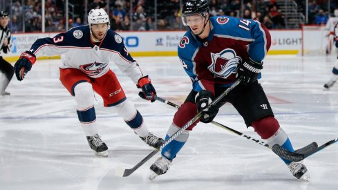 Colorado Avalanche forward Blake Comeau skates with the puck while Columbus Blue Jackets defenseman Seth Jones defends during a game at Pepsi Center in Denver, Colorado.