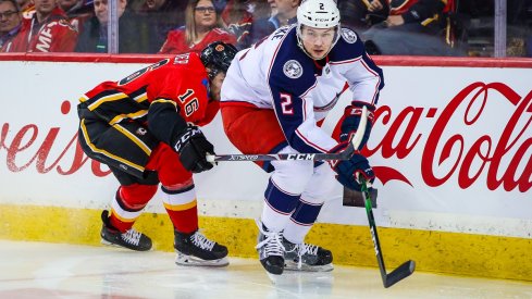 Andrew Peeke battles for the puck against the Calgary Flames