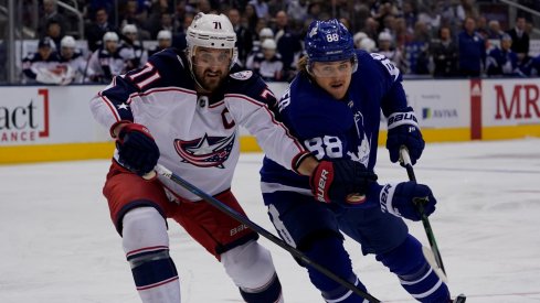 Columbus Blue Jackets forward Nick Foligno (71) and Toronto Maple Leafs forward William Nylander (88) battle for position at Scotiabank Arena. Columbus defeated Toronto in overtime.