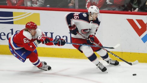 Columbus Blue Jackets defenseman Dean Kukan (46) skates with the puck as Washington Capitals left wing Carl Hagelin (62) defends in the third period at Capital One Arena.