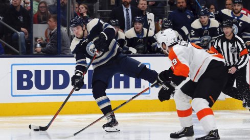 Nov 27, 2019; Columbus, OH, USA; Columbus Blue Jackets right wing Josh Anderson (77) wrists a shot on gaol as Philadelphia Flyers defenseman Ivan Provorov (9) defends during the second period at Nationwide Arena.