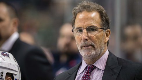 John Tortorella looks on from behind the bench