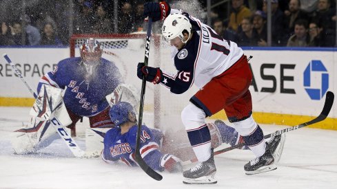 Jakob Lilja of the Columbus Blue Jackets controls the puck in front of the New York Rangers net.