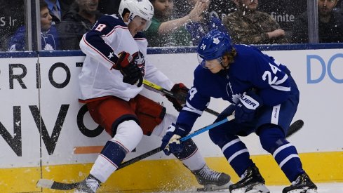 Kasperi Kapanen and Zach Werenski battle for the puck