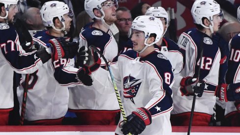 Columbus Blue Jackets defenseman Zach Werenski (8) checks Vegas Golden Knights left wing William Carrier (28) during the first period at T-Mobile Arena