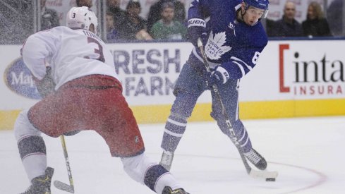 Toronto Maple Leafs forward Ilya Mikheyev (65) shoots the puck against Columbus Blue Jackets defenseman Seth Jones (3) at Scotiabank Arena. Columbus defeated Toronto in overtime.
