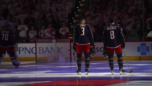 ct 12, 2019; Raleigh, NC, USA; Columbus Blue Jackets defenseman Zach Werenski (8) and Columbus Blue Jackets defenseman Seth Jones (3) looks on during the National Athem before the game against the Carolina Hurricanes at PNC Arena. The Columbus Blue Jackets defeated the Carolina Hurricanes 3-2.