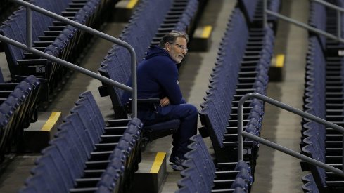 John Tortorella watches his team practice from the stands